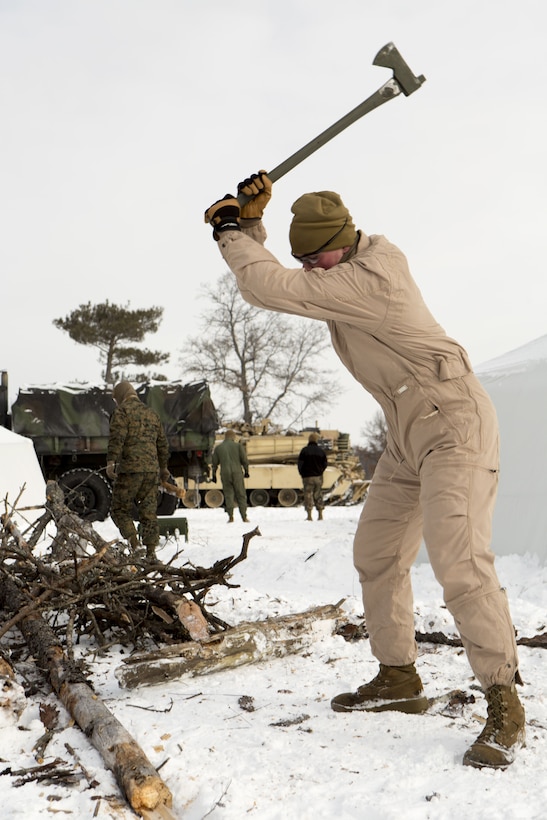 Lance Cpl. Matthew Bonestell, a tank systems mechanic with Company F, 4th Tank Battalion, 4th Marine Division, chops wood during exercise Winter Break 2018 on Camp Grayling, Michigan, Feb. 7, 2018.