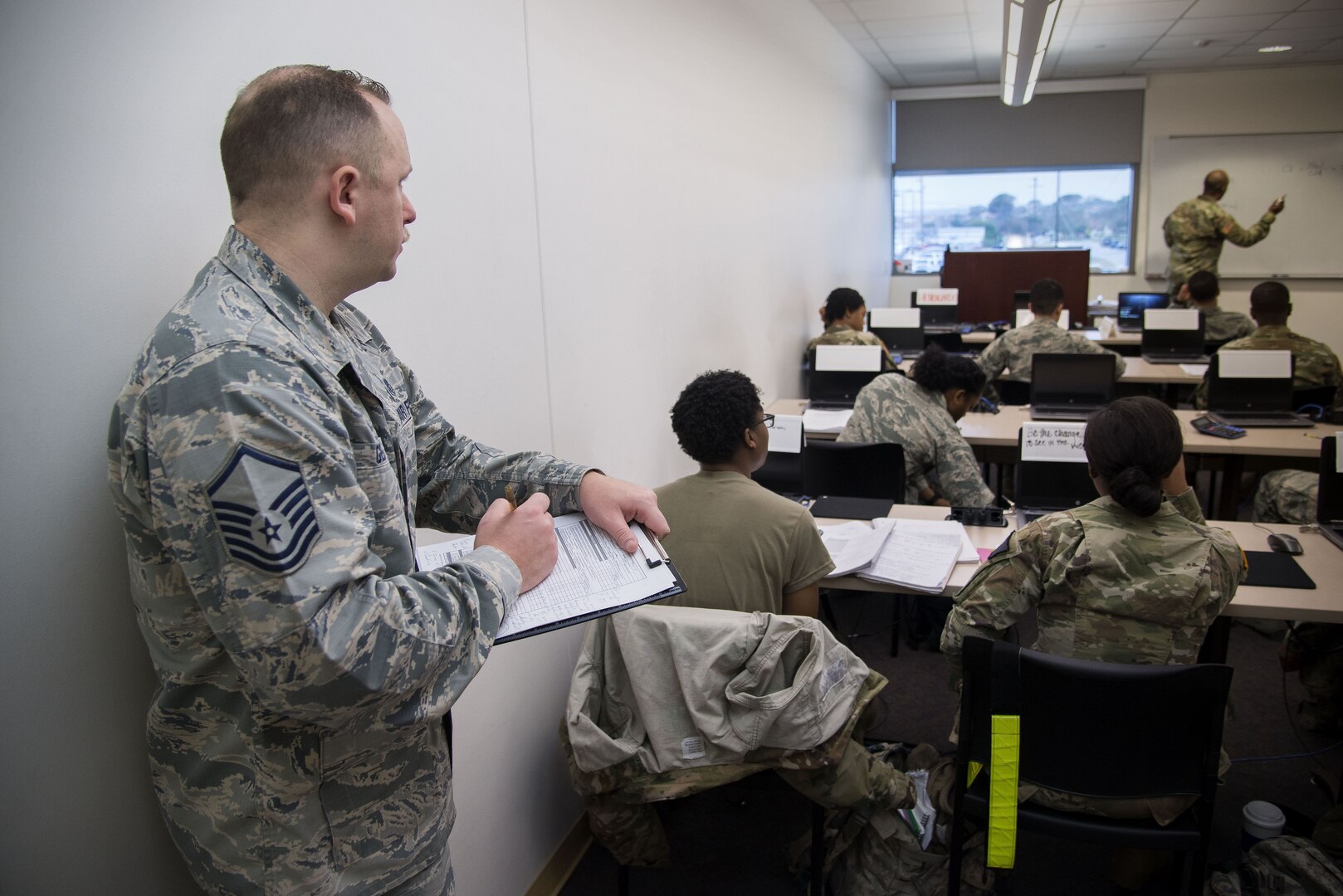 Master Sgt. Robert George, Medical Education & Training Campus pharmacy training senior enlisted leader, writes an evaluation on an instructor in training Feb. 5 at Joint Base San Antonio-Fort Sam Houston. The Department of Defense’s pharmacy technician program prepares students to perform both inpatient and outpatient pharmacy operations in both traditional and non-traditional pharmacy practices.