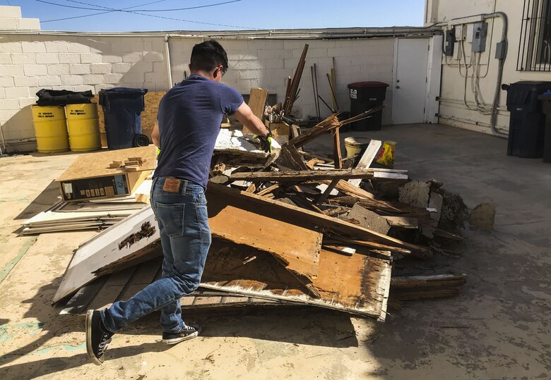 U.S. Marine Corps Lance Cpl. Joel Soriano, a strategic communication specialist assigned to Marine Corps Air Station (MCAS) Yuma’s Headquarters & Headquarters Squadron, moves rubble from a torn-down shed at St. Thomas Yuma Indian Mission in Winterhaven, Calif., Feb. 3, 2018. The mission, located out in the local Yuma community, requested help in tearing down the shed so that renovations could be made to the building. (U.S. Marine Corps photo taken by Cpl. Isaac Martinez)
