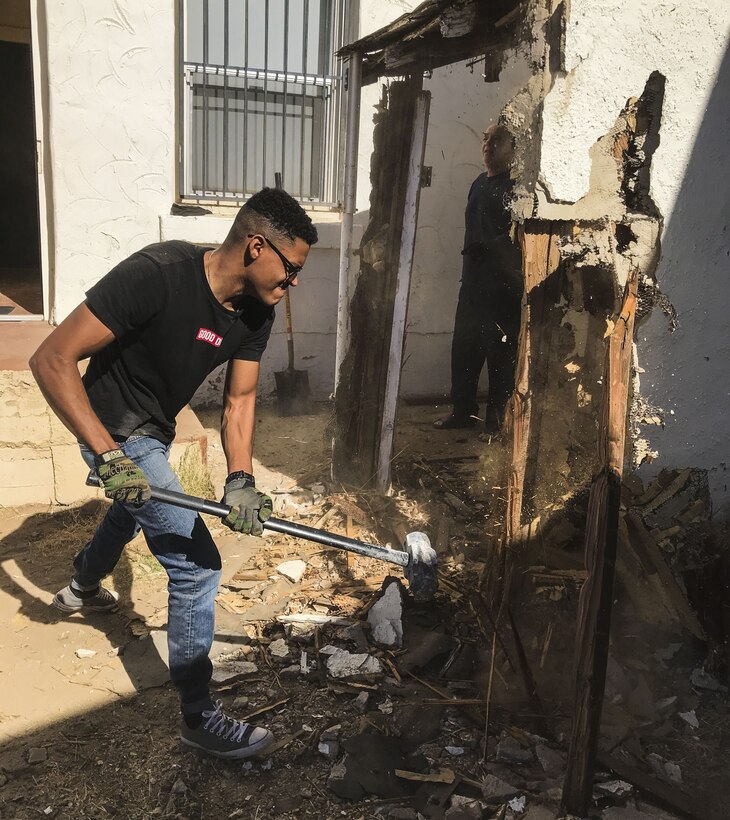 U.S. Marine Corps Cpl. Isaac D. Martinez, a strategic communication specialist assigned to Marine Corps Air Station (MCAS) Yuma’s Headquarters & Headquarters Squadron, helps knock down part of a shed at St. Thomas Yuma Indian Mission in Winterhaven, Calif., Feb. 3, 2018. The mission, located out in the local Yuma community, requested help in tearing down the shed so that renovations could be made to the building. (U.S. Marine Corps photo taken by Lance Cpl. Joel Soriano)