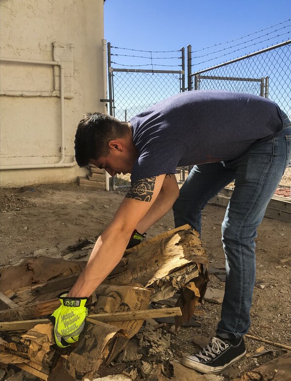 U.S. Marine Corps Lance Cpl. Joel Soriano, a strategic communication specialist assigned to Marine Corps Air Station (MCAS) Yuma’s Headquarters & Headquarters Squadron, lifts rubble from a torn-down shed at St. Thomas Yuma Indian Mission in Winterhaven, Calif., Feb. 3, 2018. The mission, located out in the local Yuma community, requested help in tearing down the shed so that renovations could be made to the building. (U.S. Marine Corps photo taken by Cpl. Isaac Martinez)