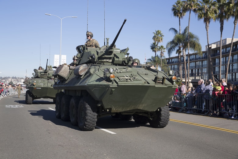 Marines with I Marine Expeditionary Force drive light armored vehicles by cheering crowds during the San Diego County Credit Union Holiday Bowl Parade, in San Diego, Dec. 28, 2017. In 2017, I MEF Marines and Sailors supported more than 140 community events.