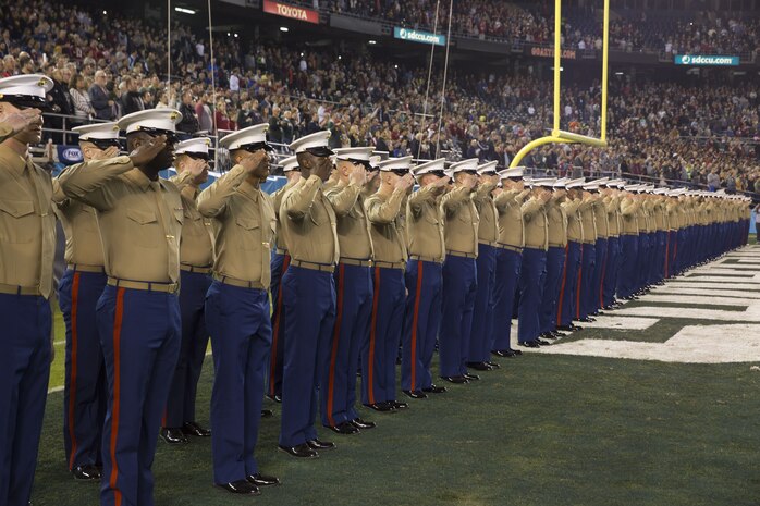Marines and sailors with I Marine Expeditionary Force salute the flag during the San Diego County Credit Union Holiday Bowl National Anthem, Dec. 28, 2017. In 2017, I MEF Marines and Sailors supported more than 140 community events.