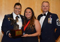 Col. Dana Nelson, 507th Air Refueling Wing vice commander, and Chief Master Sgt. David Dickson, 507th ARW command chief, present the 507th ARW Spouse of the Year award to Mrs. Jennifer Smith, Feb. 3, 2018, in Midwest City, Okla. (U.S. Air Force photo/Tech. Sgt. Samantha Mathison)