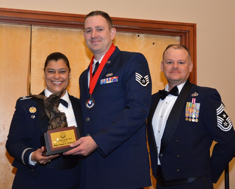 Col. Dana Nelson, 507th Air Refueling Wing vice commander, and Chief Master Sgt. David Dickson, 507th ARW command chief, present the 2017 507th ARW Noncommissioned Officer of the Year award to Staff Sgt. Casey Cottrell, 507th Logistics Readiness Squadron, Feb. 3, 2018, in Midwest City, Okla. (U.S. Air Force photo/Tech. Sgt. Samantha Mathison)