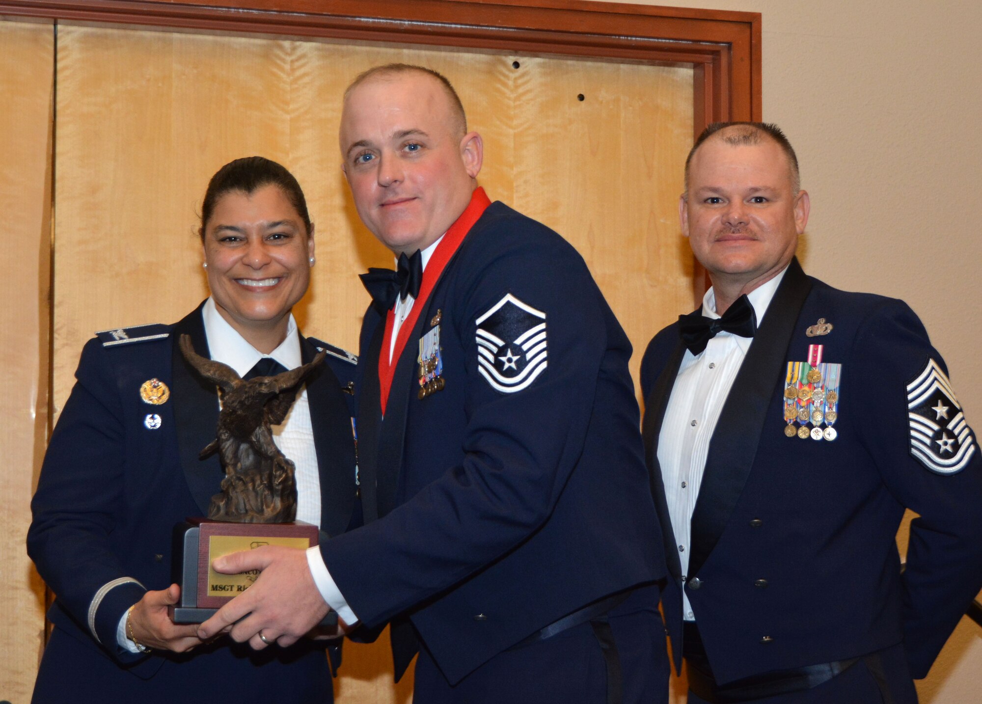Col. Dana Nelson, 507th Air Refueling Wing vice commander, and Chief Master Sgt. David Dickson, 507th ARW command chief, present the 2017 507th ARW Senior Noncommissioned Officer of the Year award to Master Sgt. Ricky Buettner, 507th Security Forces Squadron, Feb. 3, 2018, in Midwest City, Okla. (U.S. Air Force photo/Tech. Sgt. Samantha Mathison)