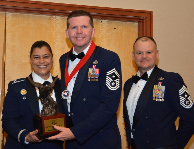 Col. Dana Nelson, 507th Air Refueling Wing vice commander, and Chief Master Sgt. David Dickson, 507th ARW command chief, present the 2017 507th ARW 1st Sgt. of the Year award to Senior Master Sgt. Ronald Pyles, 507th Force Support Squadron, Feb. 3, 2018, in Midwest City, Okla. (U.S. Air Force photo/Tech. Sgt. Samantha Mathison)