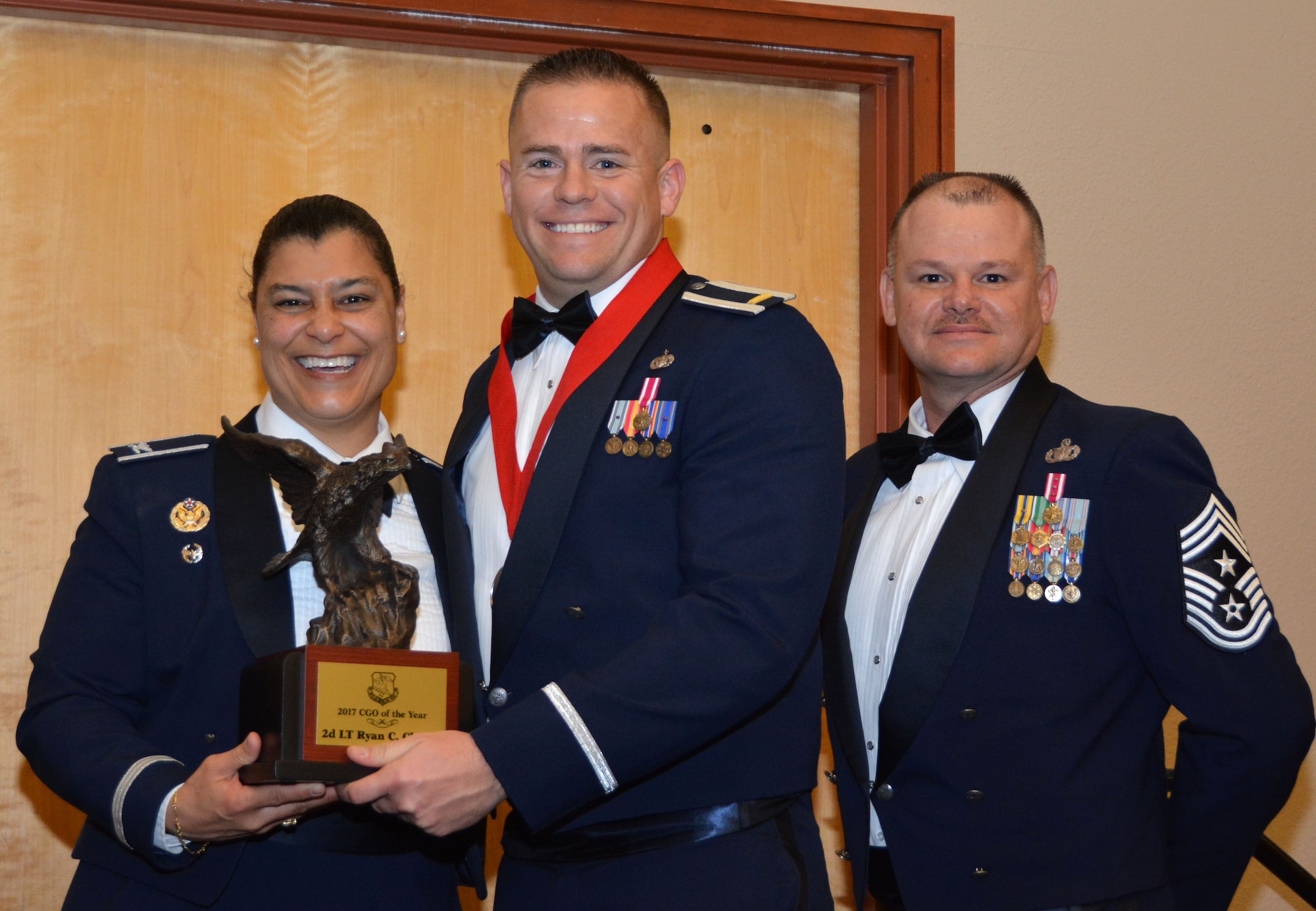Col. Dana Nelson, 507th Air Refueling Wing vice commander, and Chief Master Sgt. David Dickson, 507th ARW command chief, present the 507th ARW Company Grade Officer of the Year award to 2nd Lt. Ryan Cheney, 507th SFS, Feb. 3, 2018, in Midwest City, Okla. (U.S. Air Force photo/Tech. Sgt. Samantha Mathison)