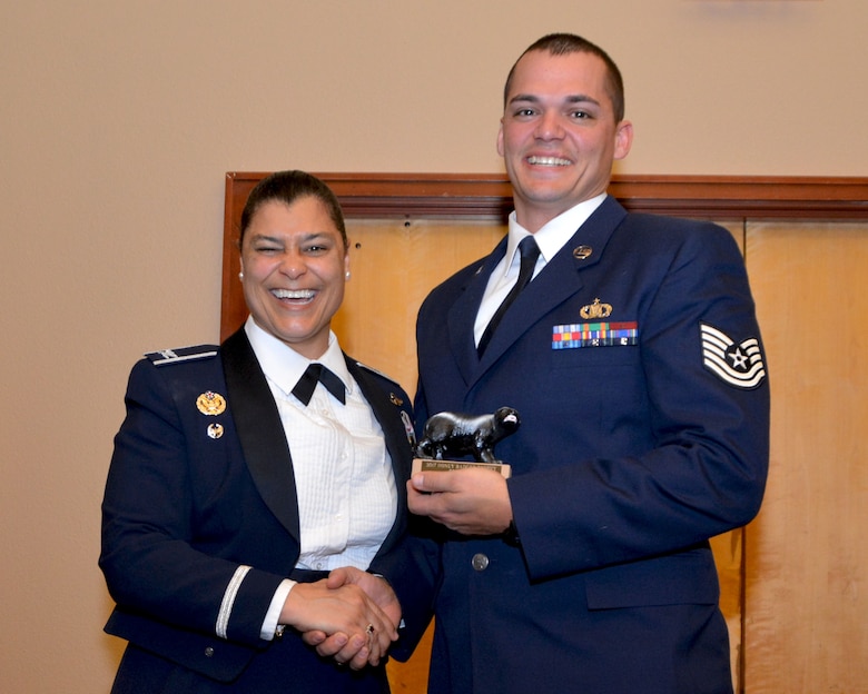 Col. Dana Nelson, 507th Air Refueling Wing vice commander, presents the 2017 507th ARW Wing Staff Honey Badger Trophy for outstanding performance to Tech. Sgt. Ryan Barnes, 507th Air Refueling Wing Command Post, Feb. 3, 2018, in Midwest City, Okla. (U.S. Air Force photo/Tech. Sgt. Samantha Mathison)