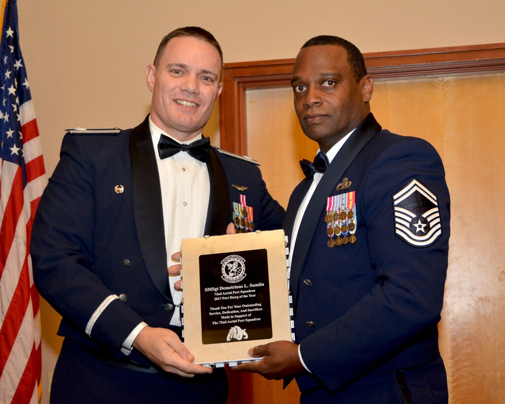 Lt. Col. Stan Young, 72nd Aerial Port Squadron commander, presents the 2017 72nd APS Port Dawg of the Year award for outstanding performance to Senior Master Sgt. Demetrious Sumlin, 72nd APS, Feb. 3, 2018, in Midwest City, Okla. (U.S. Air Force photo/Tech. Sgt. Samantha Mathison)