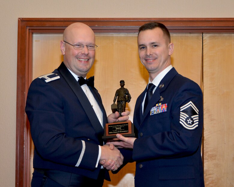 Col. Travis Caughlin, 507th Maintenance Group commander, presents the 2017 507th MXG Maintenance Professional of the Year award in the Senior Noncommissioned Officer category for outstanding performance to Senior Master Sgt. Harold Strawderman, 507th Maintenance Squadron, Feb. 3, 2018, in Midwest City, Okla. (U.S. Air Force photo/Tech. Sgt. Samantha Mathison)