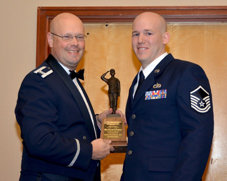 Col. Travis Caughlin, 507th Maintenance Group commander, presents the 2017 507th MXS Billy Hughes Memorial Award for outstanding performance to Master Sgt. Matthew Pearsall, 507th Aircraft Maintenance Squadron, Feb. 3, 2018, Midwest City, Okla. (U.S. Air Force photo/Tech. Sgt. Samantha Mathison)