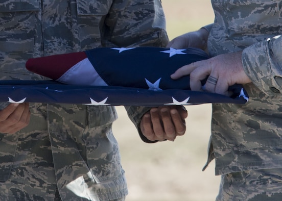 U.S. Air Force Senior Airman Cody Burgan, Senior Master Sgt. David B. Reid Airmen Leadership School (ALS), folds a flag while Senior Airman Esteban Cruz, 20th ALS flag detail team member, holds the flag at Shaw Air Force Base, S.C., Feb. 2, 2018.