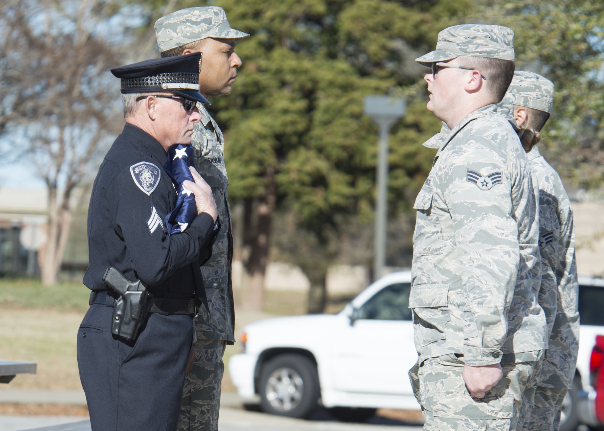 Gary Fowler, Sumter City Police Department emergency management coordinator, holds a flag presented by 20th Fighter Wing Airmen at Shaw Air Force Base, S.C., Feb. 2, 2018.