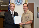 180129-N-YG220-044 ARLINGTON, Va. (Jan. 29, 2018) Rear Adm. David Hahn, chief of naval research (CNR), presents Dr. Gerald C. Manke with a Meritorious Service Award during a ceremony held at the Office of Naval Research. (U.S. Navy photo by Moraima Johnston/Released)