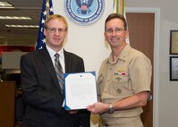 180129-N-YG220-044 ARLINGTON, Va. (Jan. 29, 2018) Rear Adm. David Hahn, chief of naval research (CNR), presents Dr. Gerald C. Manke with a Meritorious Service Award during a ceremony held at the Office of Naval Research. (U.S. Navy photo by Moraima Johnston/Released)