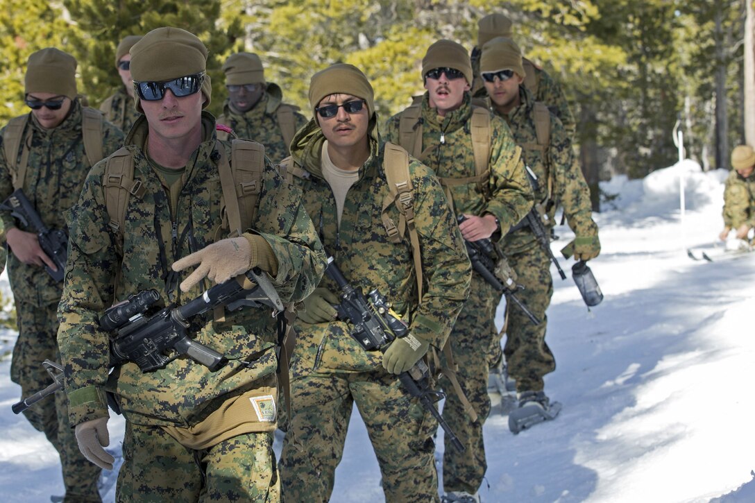 Marines march in the snow.