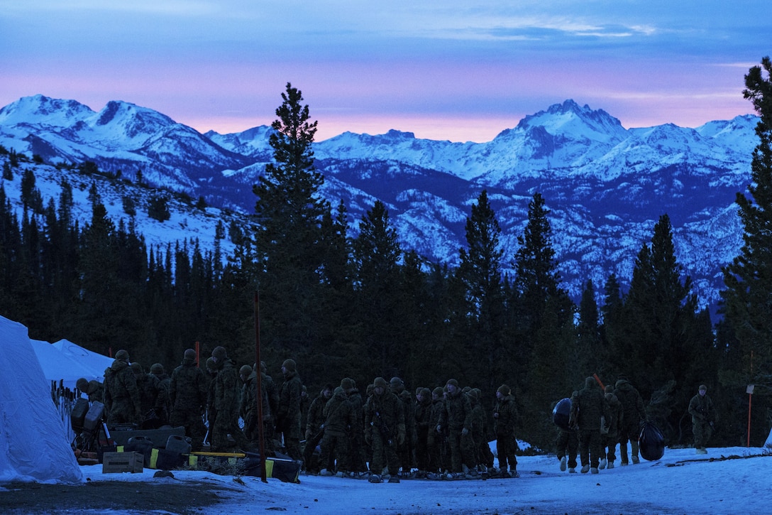 Marines assemble at sunrise in the mountains.