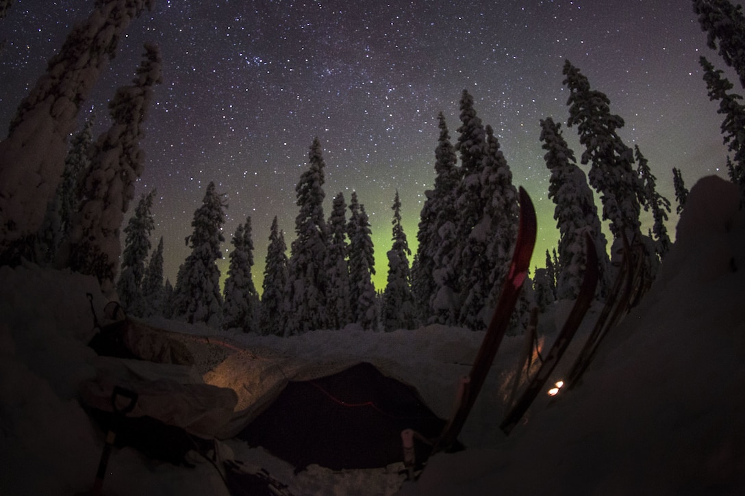 Participants of the Swedish Basic Winter Warfare Course sleep in the field under the sky covered with northern lights and stars in Arvidsjaur, Sweden, Jan. 23, 2018. Marines from the Black Sea Rotational Force and the 26th Marine Expeditionary Unit, along with troops from 9 other countries, participated in the Swedish Basic Winter Warfare Course. The course developed the participants’ capability to survive in cold-weather environment, march on skis, apply his or hers tactical skills at individual and squad levels, and to lead smaller units in winter warfare in subarctic winter conditions. (U.S. Marine Corps photo by SSgt. Marcin Platek/Released)
