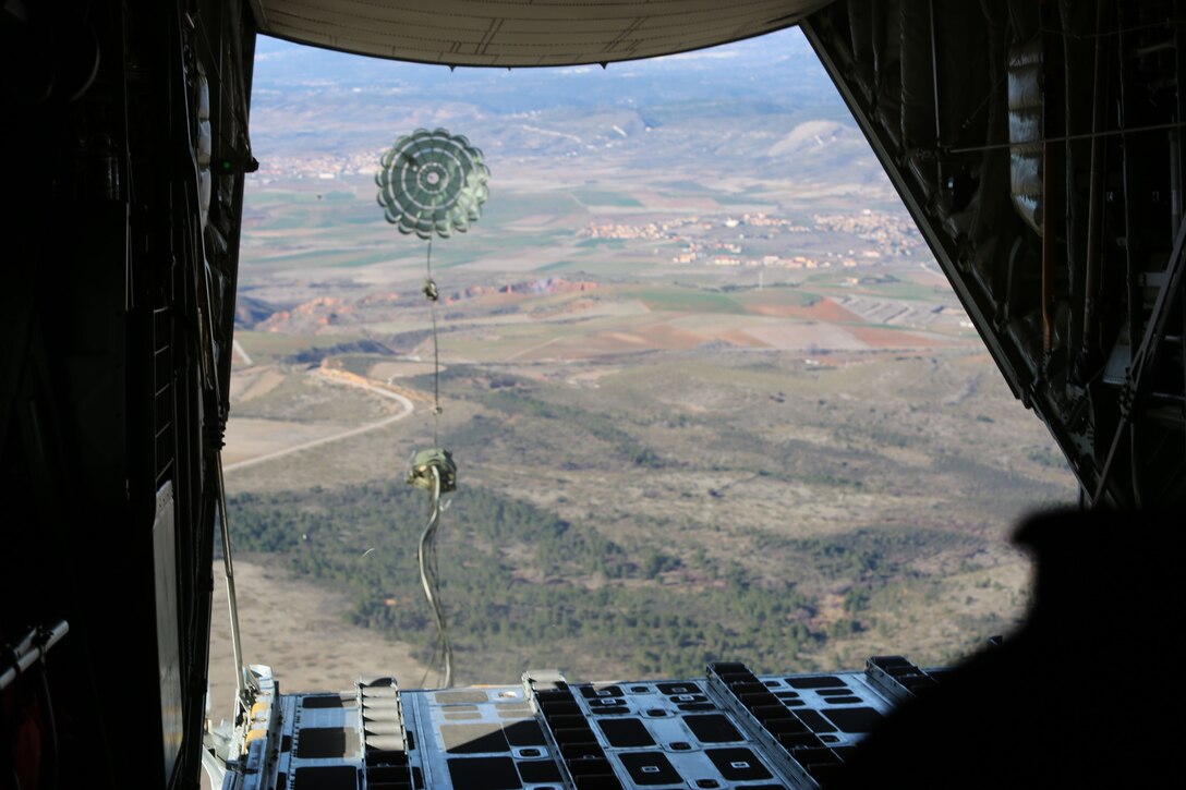 A load ejects from a U.S. Marine Corps KC-130J Hercules aircraft during Operation Death From Above, a bilateral training exercise with U.S. Marines assigned to Special Purpose Marine Air-Ground Task Force-Crisis Response-Africa and Spanish Armed Forces paratroopers, near Torrejón Air Base, Spain, Jan. 22, 2018. SPMAGTF-CR-AF is deployed to conduct limited crisis-response and theater-security operations in Europe and Africa. (U.S. Marine Corps Photo by Lance Cpl. Patrick Osino)