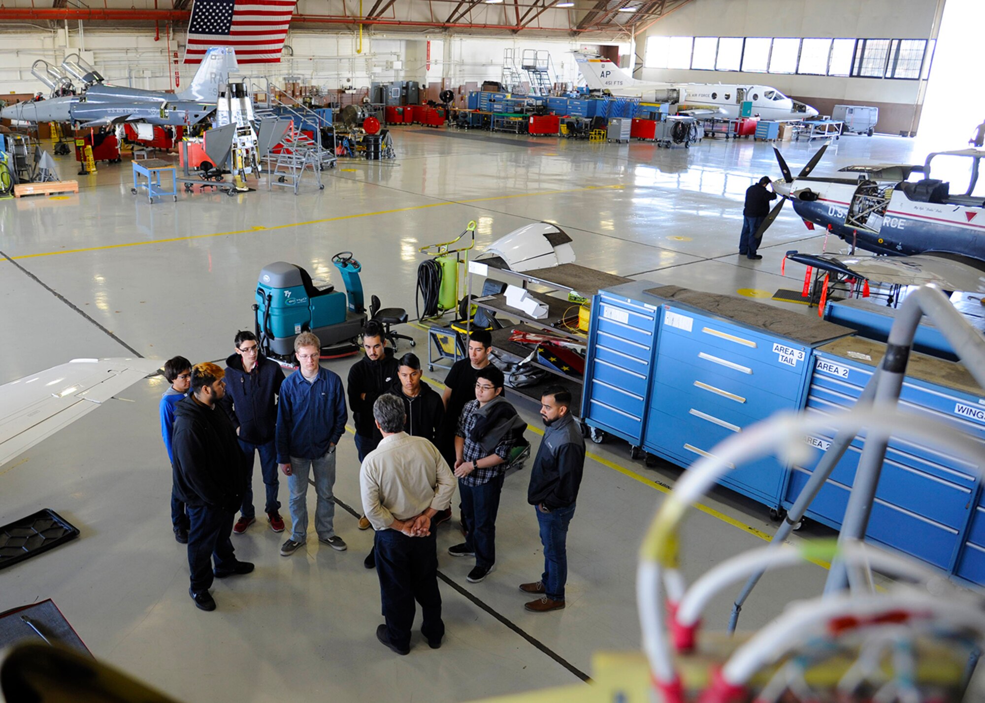 Larry Welfel, 12th Maintenance Squadron, T-1A aircraft technician, briefs Wagner high school students inside the phase inspection facility during the job shadow tour, Feb. 2, 2018, Joint Base San Antonio-Randolph, Texas.
