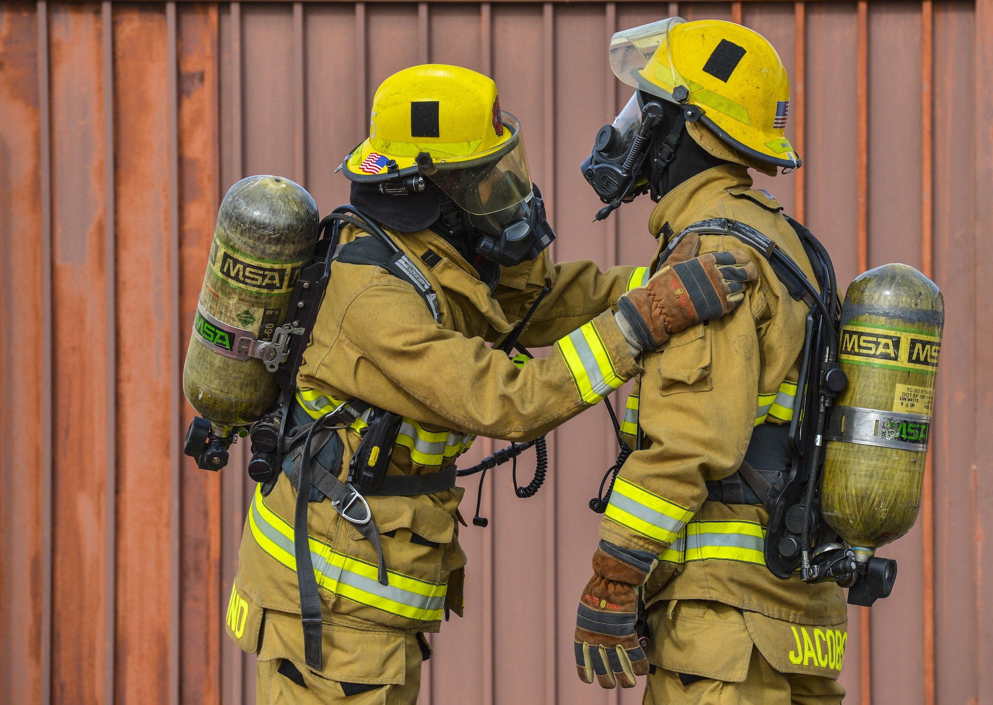 Airmen assigned to the 56th Civil Engineer Squadron check each other’s gear in preparation for structural firefighting training at Luke Air Force Base, Ariz., Jan. 16, 2018. The goal of the training was to clear heat and smoke from a contained structure to increase chances of survival for occupants trapped inside. (U.S. Air Force photo/Airman 1st Class Caleb Worpel)