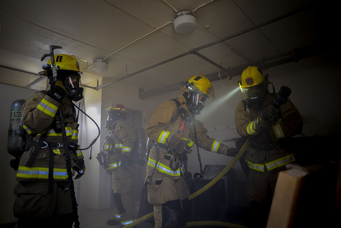 Airmen assigned to the 56th Civil Engineer Squadron inspect a building during structural firefighting training at Luke Air Force Base, Ariz., Jan. 16, 2018. Firefighters checked the structural integrity of the building after the exercise to better assess how to respond to future scenarios. (U.S. Air Force photo/Airman 1st Class Caleb Worpel)
