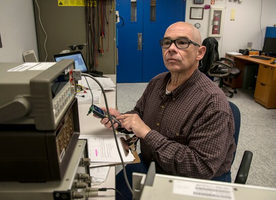 Dave McMillan, quality assurance evaluator for Kirtland’s Precision Measurement Equipment Laboratory, performs quality review tests on equipment. McMillan was presented with an AFMETCAL Excellence Coin in recognition of his outstanding work as a quality assurance evaluator during a recent inspection.