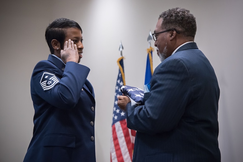 Master Sgt. Robin Robertson, 81st Training Wing first sergeant, presents a retirement flag Gary Wallace, 53rd Weather Reconnaissance Squadron aviation resources management technician, during his retirement ceremony Feb. 2, 2018 at Keesler Air Force Base, Mississippi. (U.S. Air Force photo by Staff Sgt. Heather Heiney)