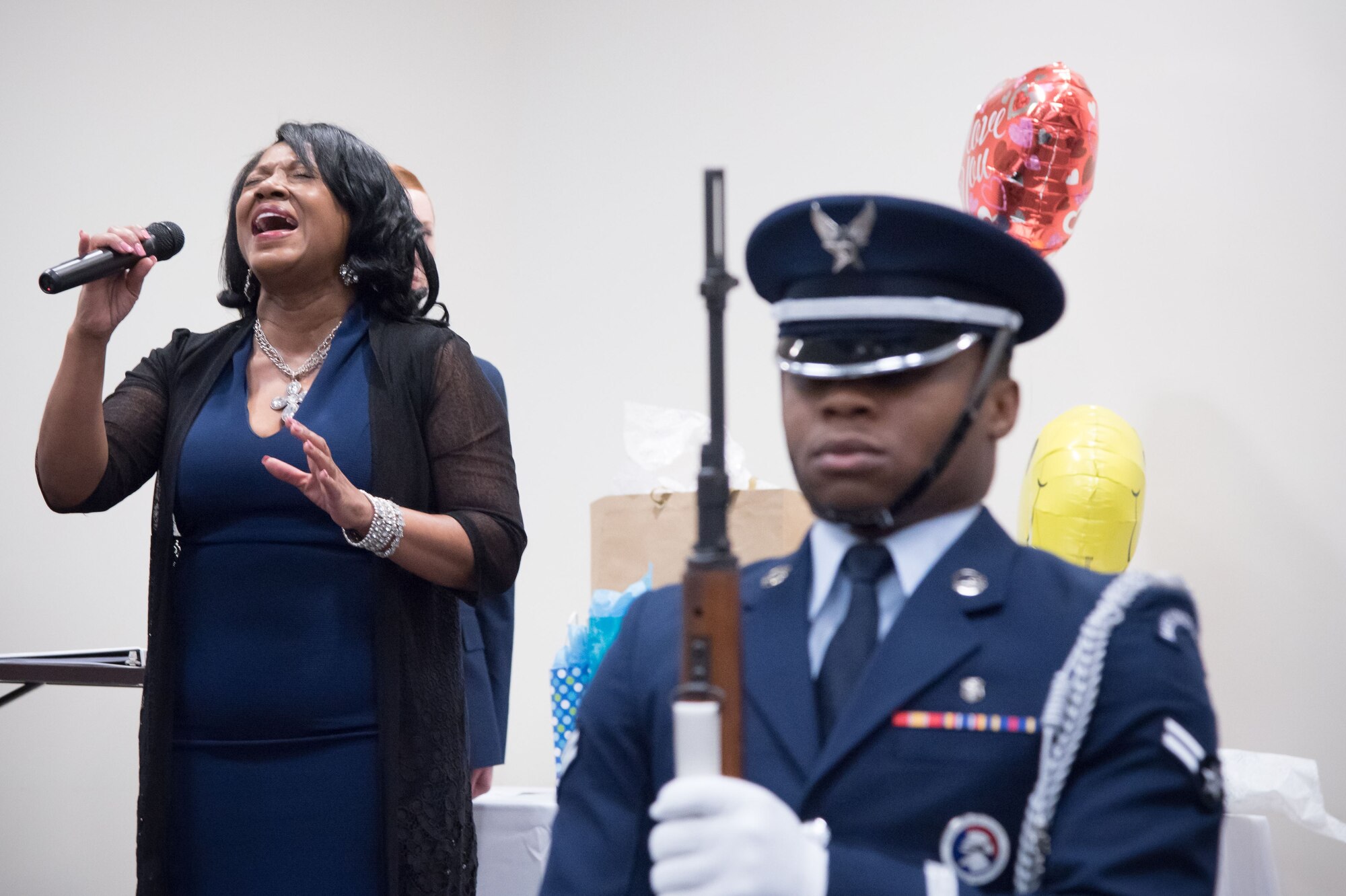 Catherine Brinson sings the National Anthem during a retirement ceremony for Gary Wallace, 53rd Weather Reconnaissance Squadron aviation resource management technician, Feb. 2, 2018 at Keesler Air Force Base, Mississippi. (U.S. Air Force photo by Staff Sgt. Heather Heiney)