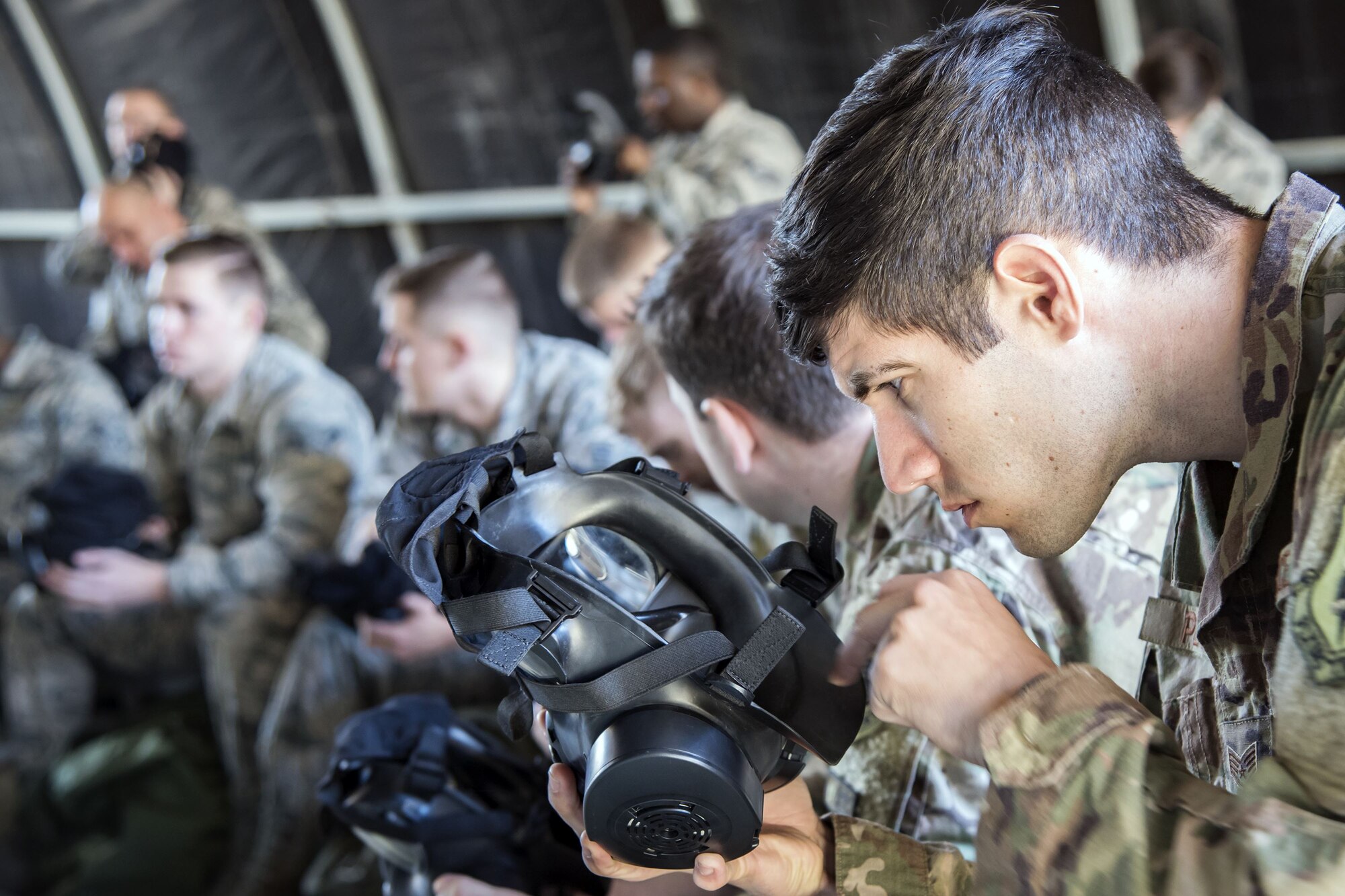 Staff Sgt. Robert Pease, 347th Operations Support Squadron aerial delivery rigger, inspects his gas mask, Feb. 1, 2018, at Moody Air Force Base, Ga. Airmen participated in a chemical, biological, radiological and nuclear defense (CBRNE) class to better prepare them to combat enemy attacks while also familiarizing them with mission-oriented protective posture (MOPP) gear. (Air Force photo by Airman Eugene Oliver)