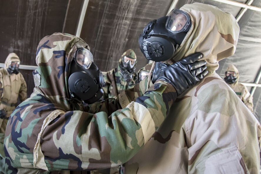 Staff Sgt. Christopher Windley, 23d Force Support Squadron fitness specialist, left, performs a seal check on Staff Sgt. Ryan Cox, 820th Combat Operations Squadron combat arms instructor, Feb. 1, 2018, at Moody Air Force Base, Ga. Airmen participated in a chemical, biological, radiological and nuclear defense (CBRNE) class to better prepare them to combat enemy attacks while also familiarizing them with mission-oriented protective posture (MOPP) gear. (Air Force photo by Airman Eugene Oliver)
