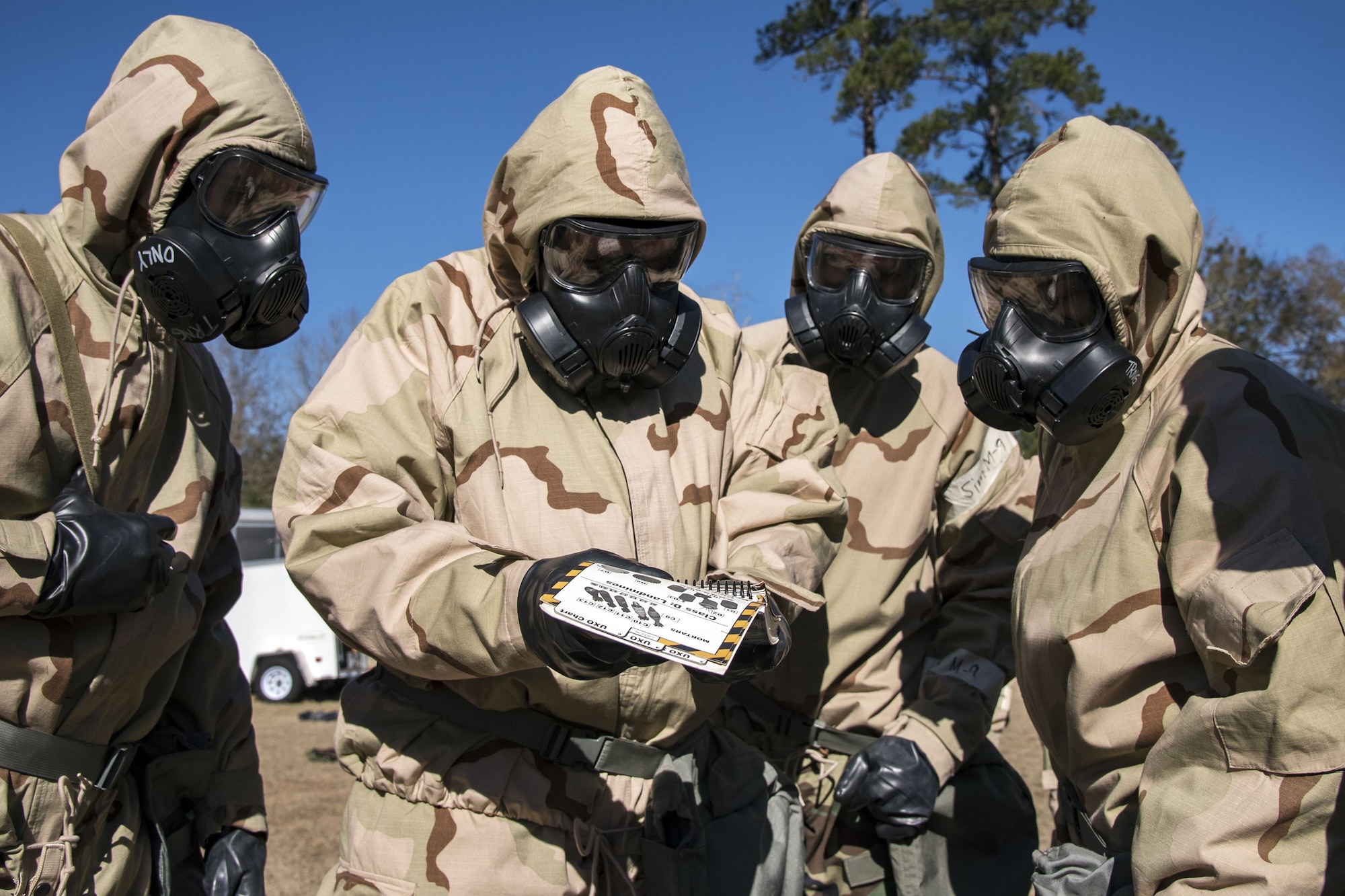 Airmen read an Airman’s manual, Feb. 5, 2018, at Moody Air Force Base, Ga. Airmen participated in a chemical, biological, radiological and nuclear defense (CBRNE) class to better prepare them to combat enemy attacks while also familiarizing them with mission-oriented protective posture (MOPP) gear. (Air Force photo by Airman Eugene Oliver)