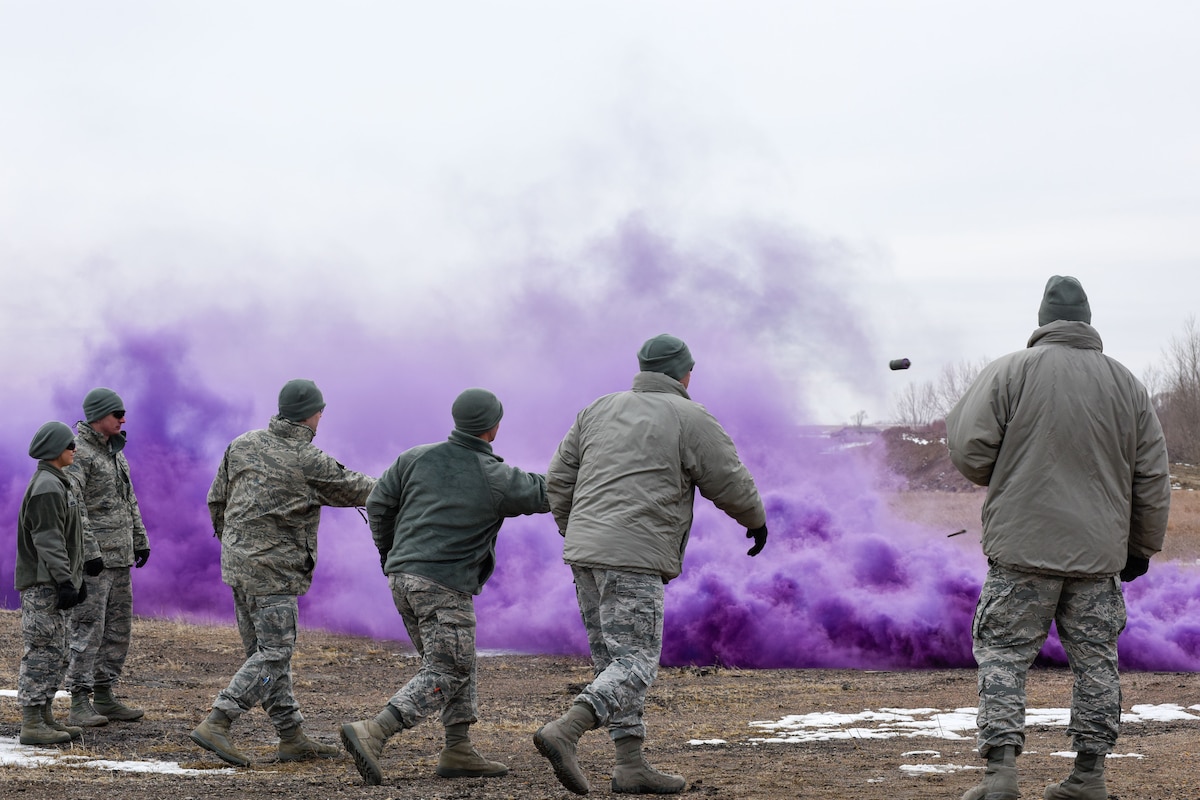 114th Security Forces Squadron members deploy smoke grenades during Explosive Ordinance Disposal (EOD) training at a range a few miles west of Sioux Falls, Feb. 3, 2018.