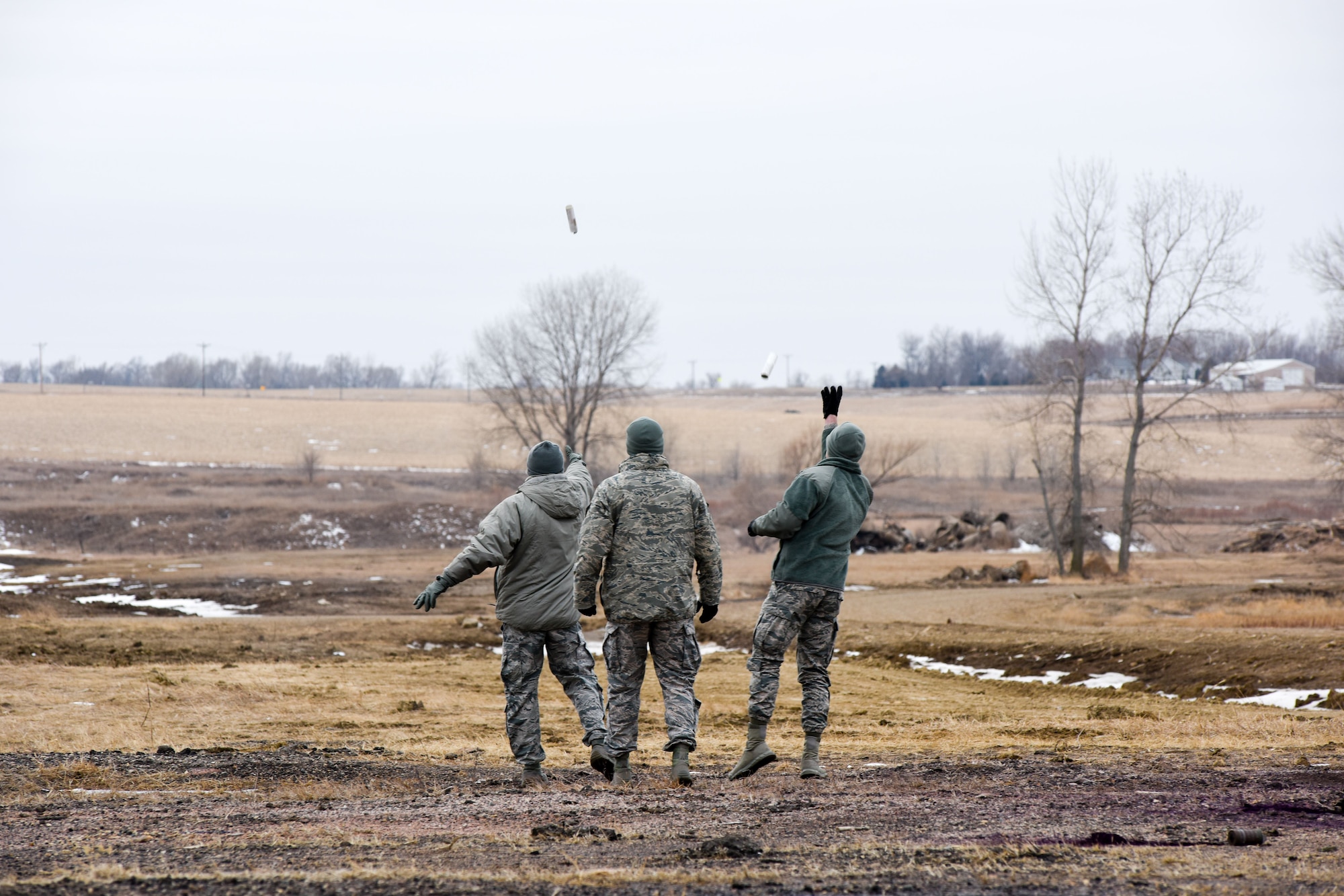 114th Security Forces Squadron members deploy ground burst simulators during training at a range near Joe Foss Field, S.D. Feb. 3, 2018.