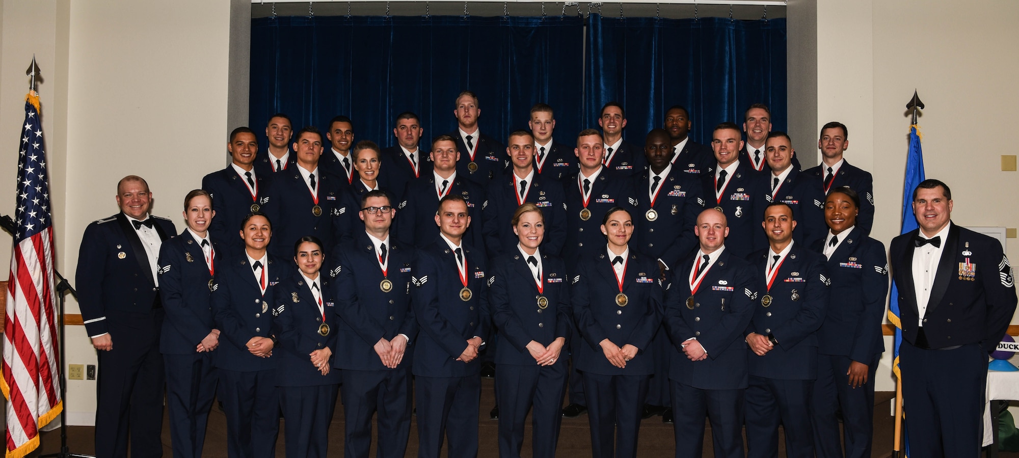 Col. Mathew Dillow, 90th Missile Wing vice commander and Chief Master Sgt. James Gray, 90th Medical Group chief enlisted manager, pose with the graduating Airman Leadership School Class 18-C students at F.E. Warren Air Force Base, Wyo., Feb. 7, 2018. Enlisted Airmen must complete this professional military education course to become supervisors of other Airmen. (U.S. Air Force photo by Airman 1st Class Braydon Williams)