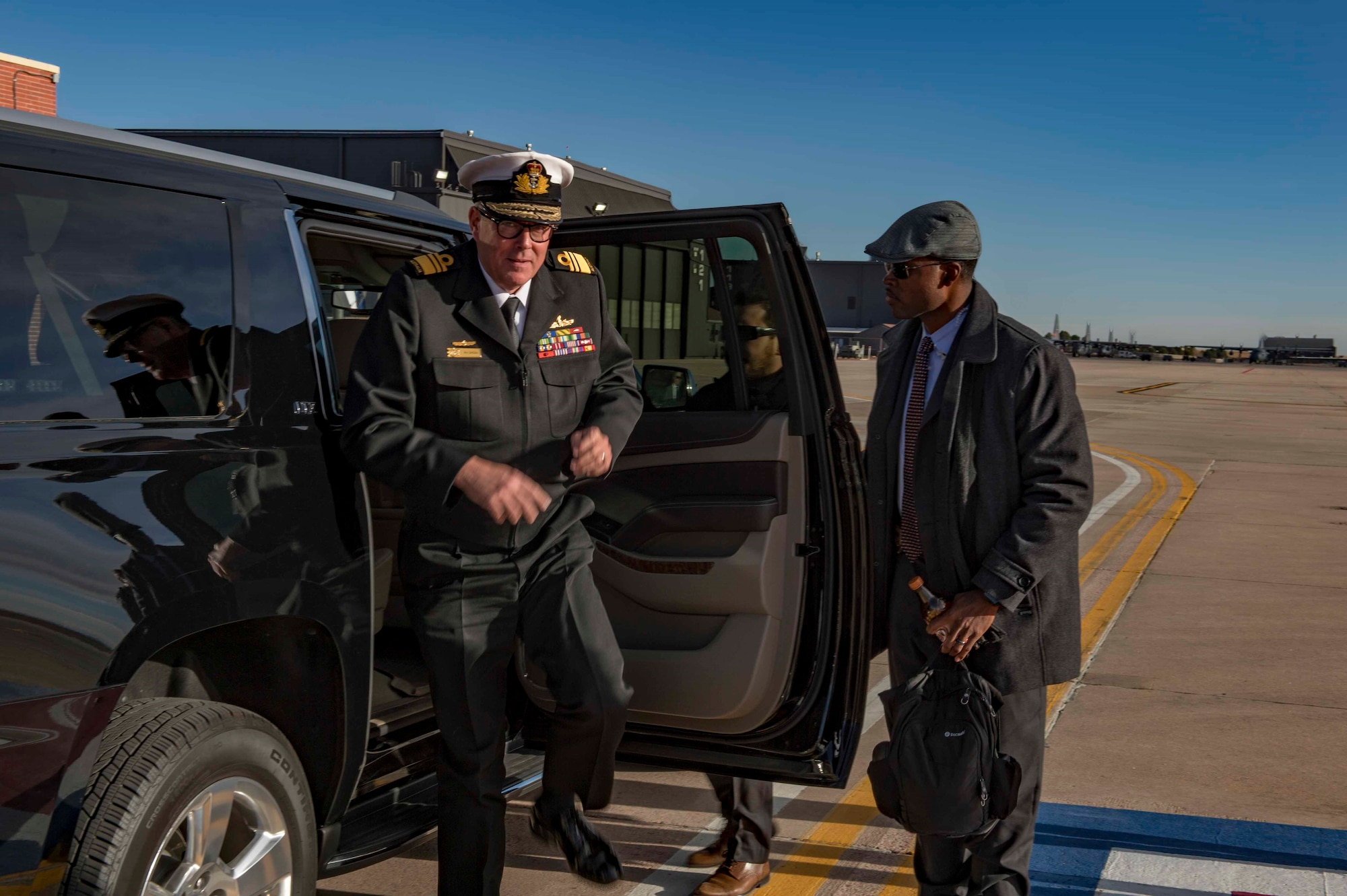 AFOSI SA Donavan Muir (right) assists Vice Adm. Ray Griggs, Vice Chief of the Australian Defence Force, at Peterson AFB, Colo., Dec. 3, 2017. SA Muir was part of a PSO mission providing security for Griggs. (U.S. Air Force photo by Dave Grim)