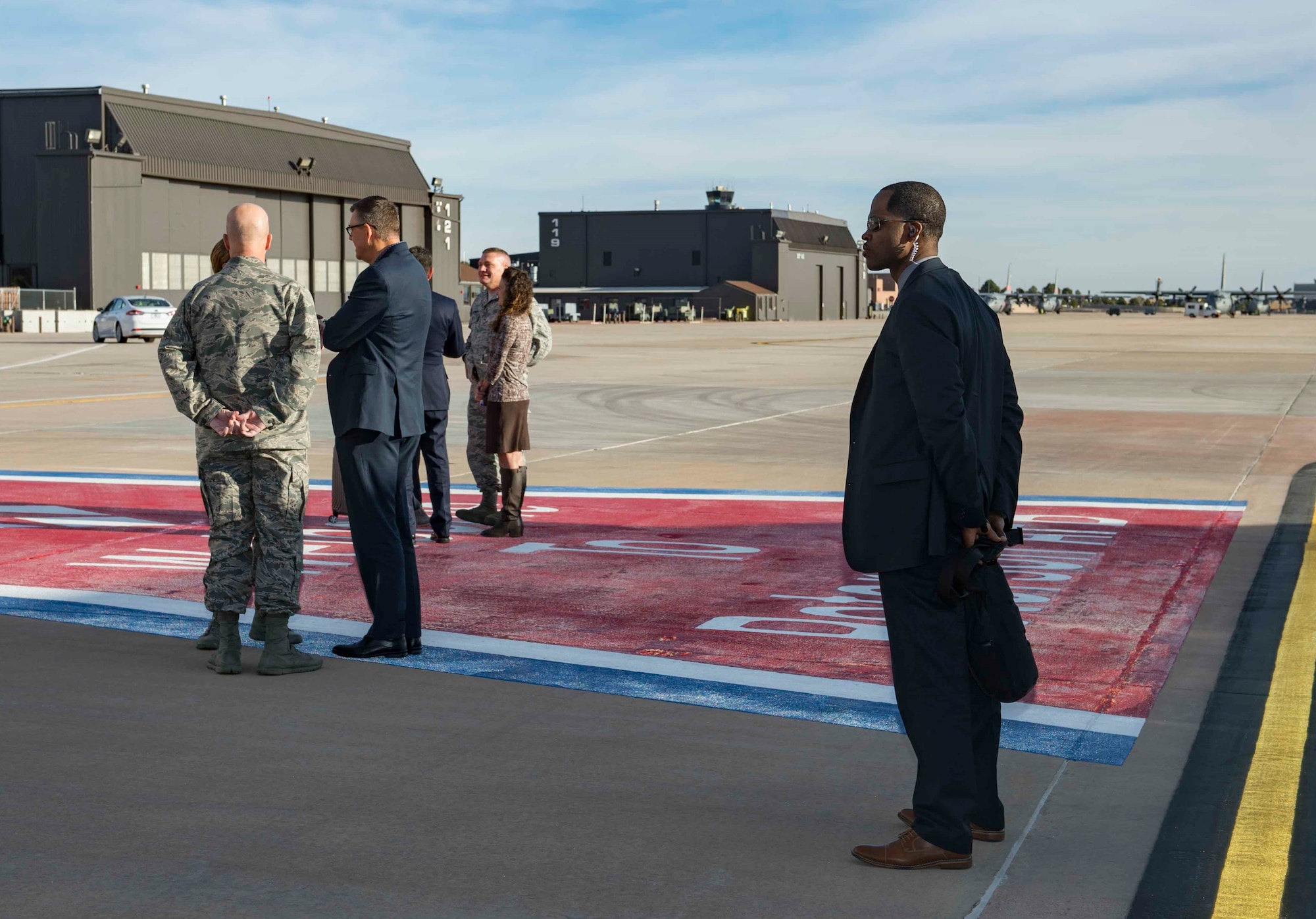 AFOSI SA Donavan Muir stands at the ready at Peterson AFB, Colo., Dec. 3, 2017, as Gen. Lori Robinson, commander of U.S. Northern Command and North American Aerospace Defense Command, Gen. Jay Raymond, AFSC and Joint Force Space Component commander and Col. Eric Dorminey, vice commander of the 21SW, speak with Vice Adm. Ray Griggs, Vice Chief of the Australian Defence Force. SA Muir was part of a Protective Services Operations mission providing security for Griggs. (U.S. Air Force photo by Dave Grim)