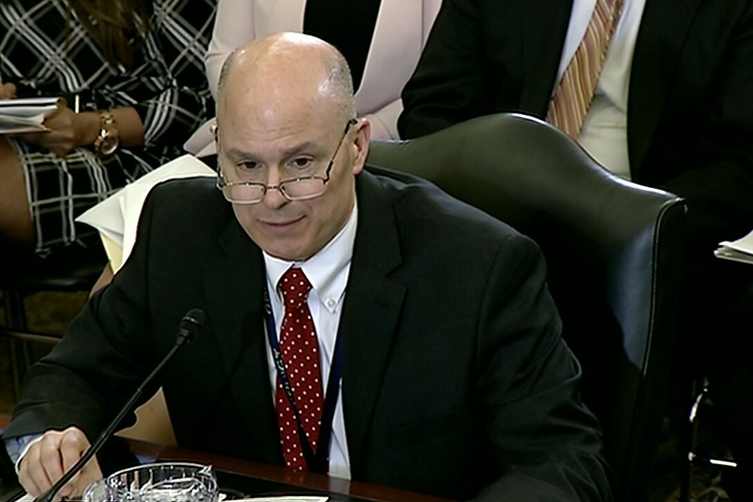 A Defense Department official sits behind a table at a Senate hearing.
