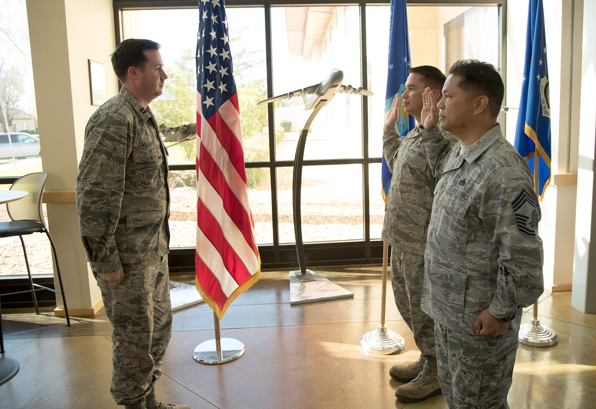 Representing more than 50 years of service combined, two 349th Air Mobility Wing chief master sergeants reenlisted Feb. 8, 2018.