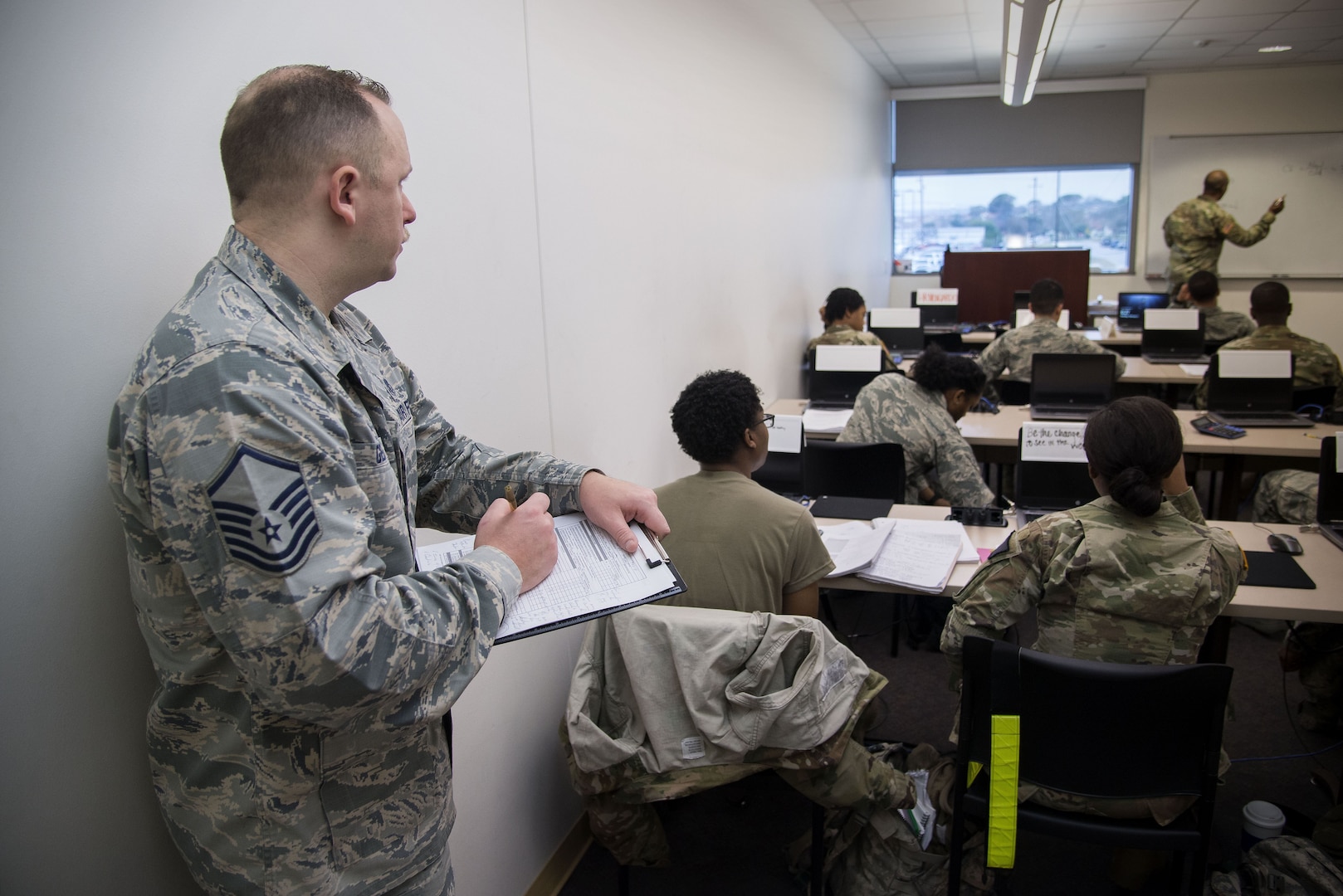 Master Sgt. Robert George, Medical Education & Training Campus pharmacy training senior enlisted leader, writes an evaluation on an instructor in training Feb. 5 at Joint Base San Antonio-Fort Sam Houston. The Department of Defense’s pharmacy technician program prepares students to perform both inpatient and outpatient pharmacy operations in both traditional and non-traditional pharmacy practices.