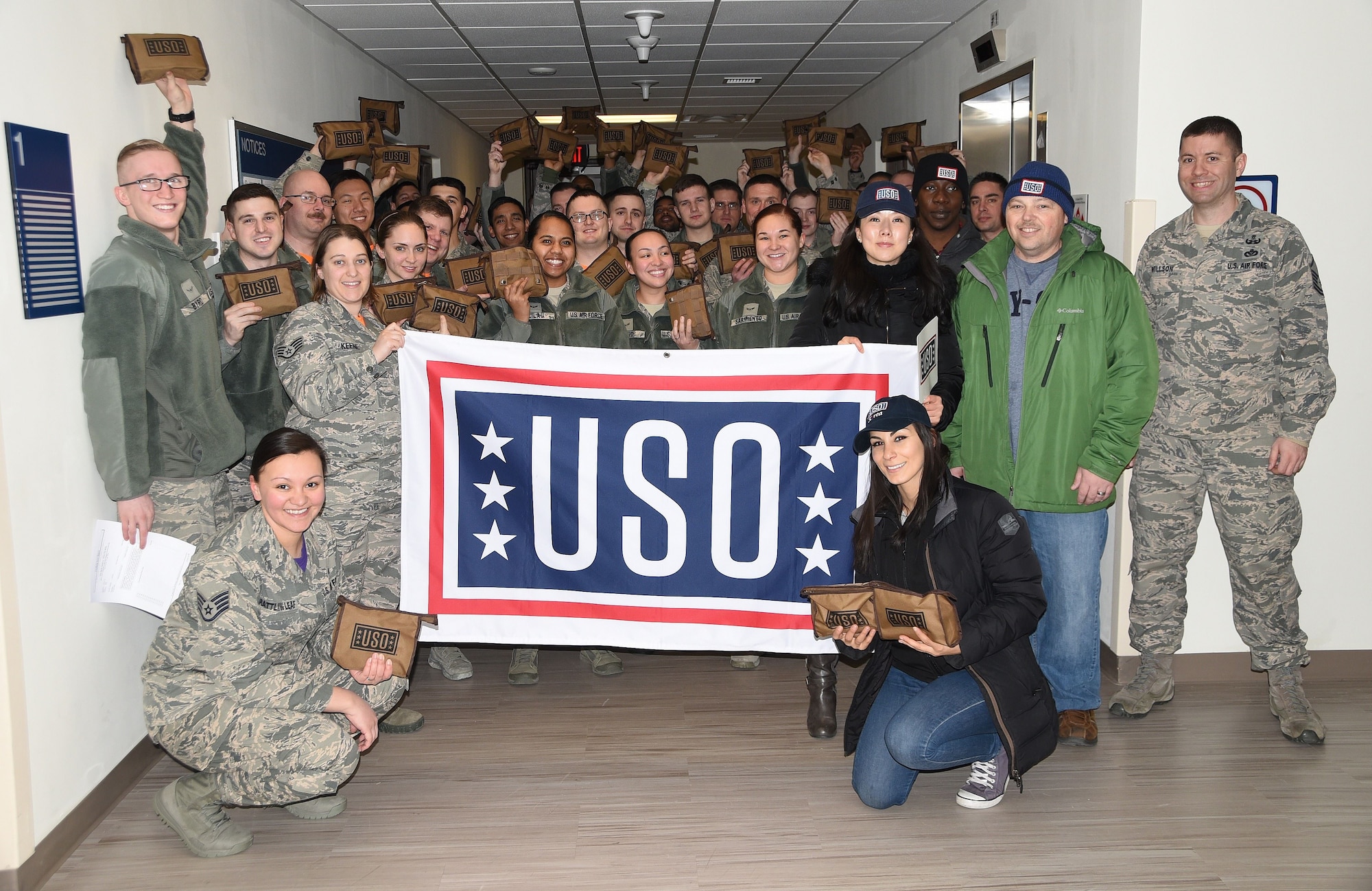 Members from the United Service Organizations based at Osan Air Base, Republic of Korea pose for a photo with the 8th Communications Squadron, Jan. 26, 2018. Due to Kunsan being a true remote tour,  the USO  from Osan visit once a month providing care packages to U.S. service members to show their support.  (U.S. Air Force photo by Senior Airman Colby L. Hardin)