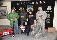 Members from the United Service Organizations based at Osan Air Base, Republic of Korea pose for a photo, Jan. 26, 2018. The USO visited Kunsan AB, ROK to hand out care-packages to the service members on base. (U.S. Air Force photo by Senior Airman Colby L. Hardin)