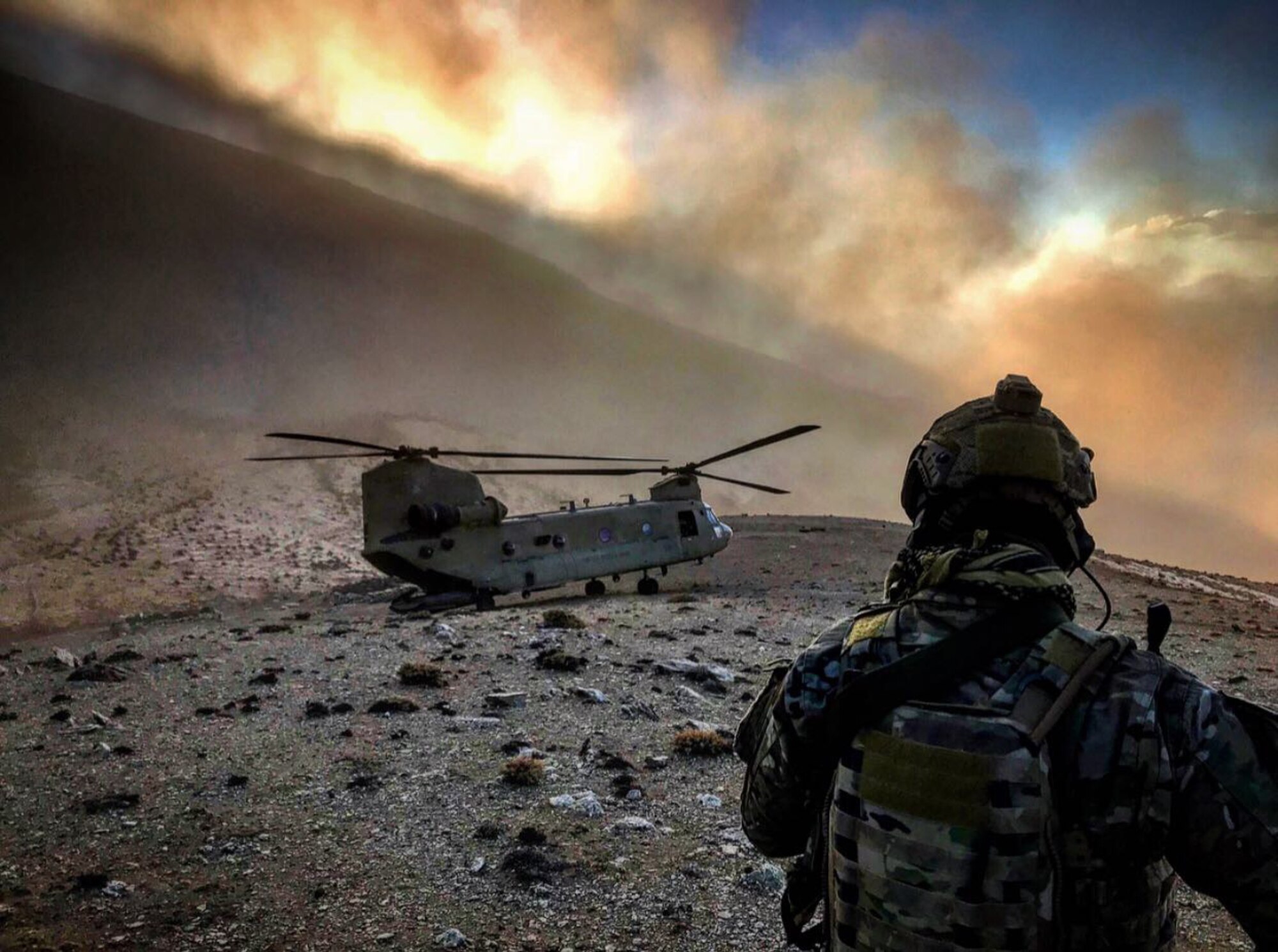 A member of the 83rd Expeditionary Rescue Squadron observes a U.S. Army CH-47 Chinook at an undisclosed location in Afghanistan. The 83rd ERQS is Air Force Central Command’s first dedicated joint personnel recovery team, utilizing Air Force Guardian Angel teams and Army CH-47 Chinook crews. (Courtesy photo)