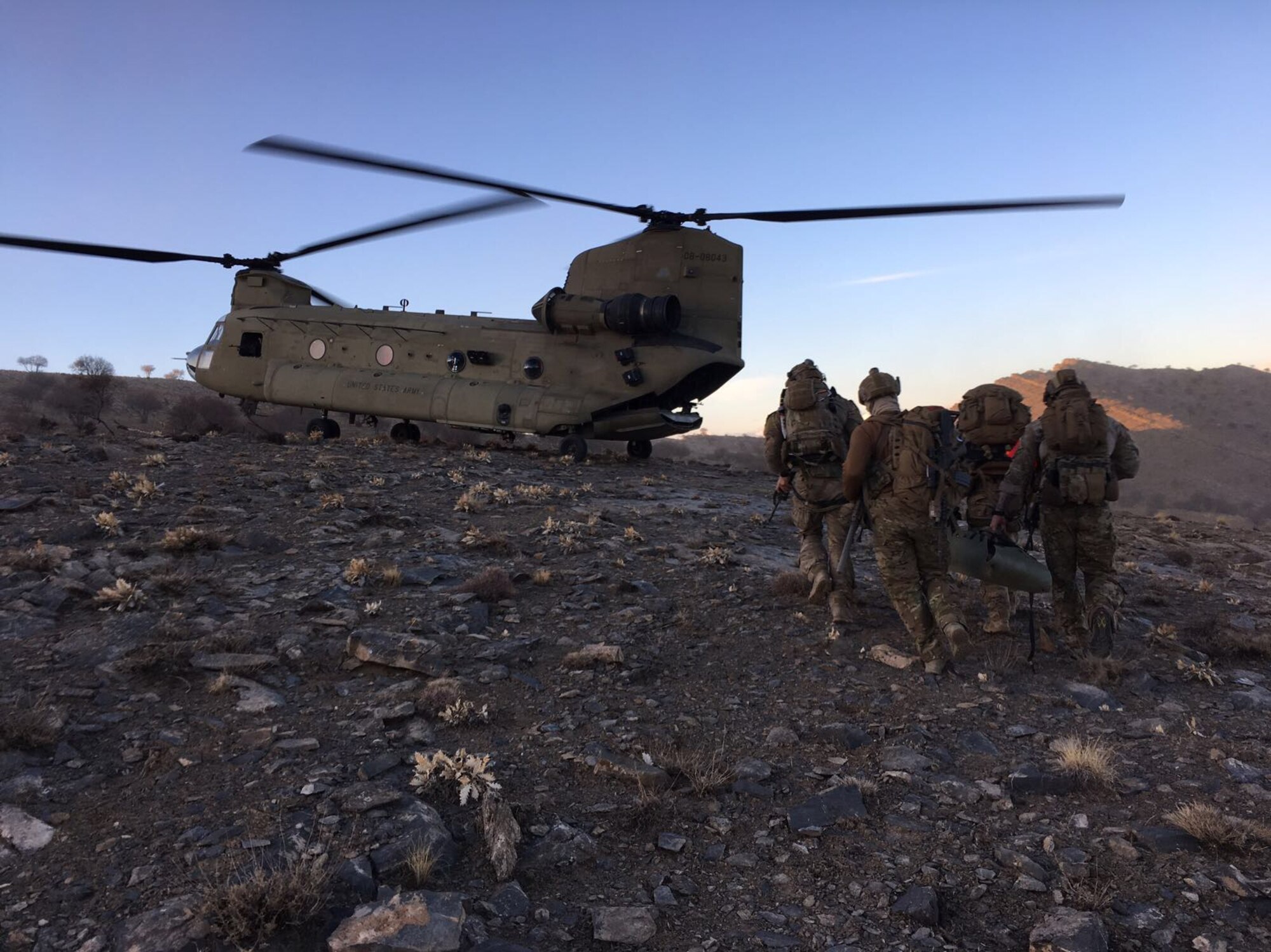 Members of the 83rd Expeditionary Rescue Squadron prepare to board a U.S. Army CH-47 Chinook at an undisclosed location in Afghanistan The 83rd ERQS, made up of Army Chinook crews and Air Force Guardian Angel teams, provide Air Force Central Command with a combat search and rescue capability. (Courtesy photo)