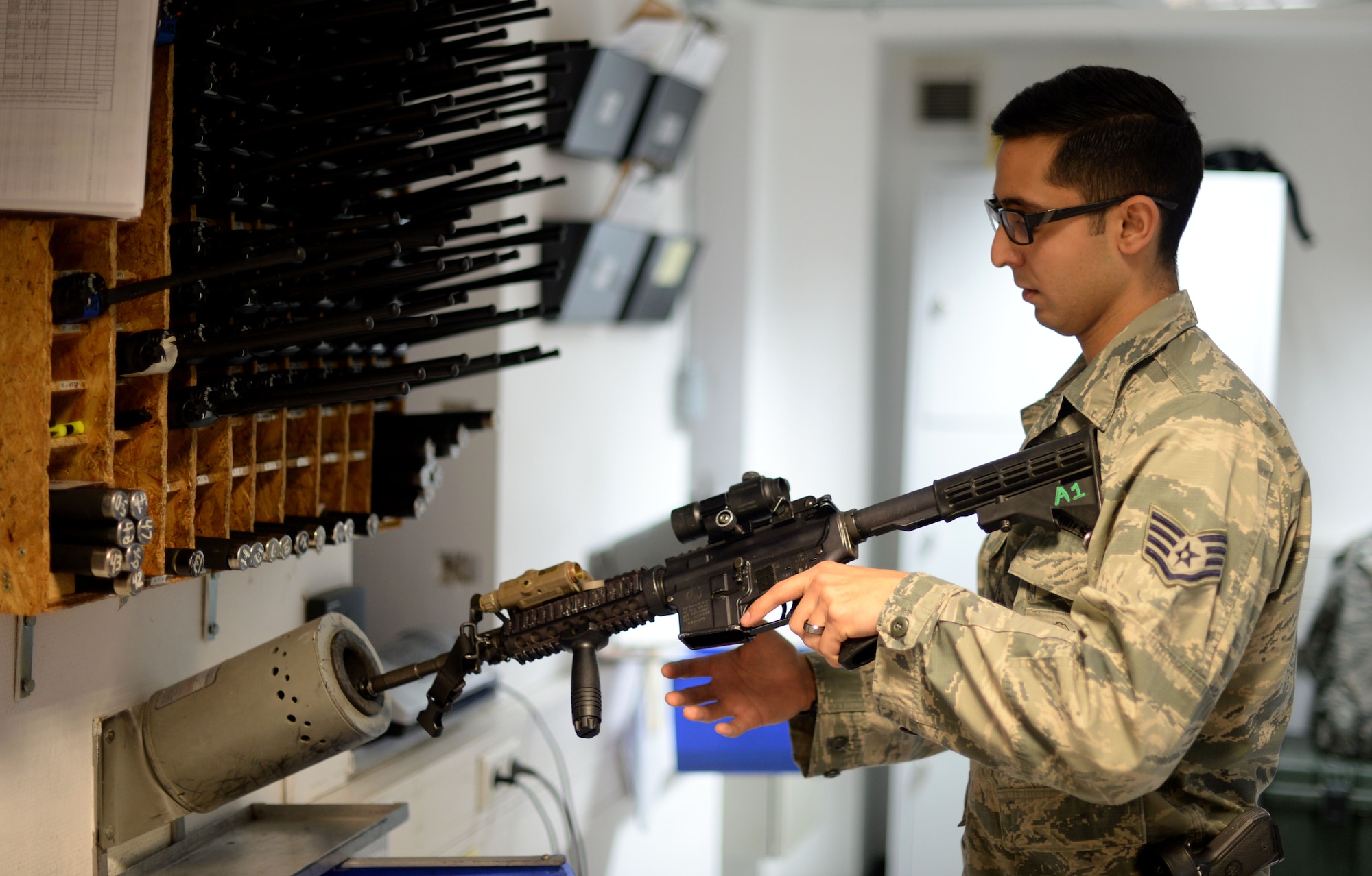 Staff Sgt. Alexander Scott, 52nd Security Forces Squadron armory noncommissioned officer in charge, demonstrates clearing procedures on a weapon at Spangdahlem Air Base, Germany, Jan. 26, 2018. Scott's contributions to safety led to his selection as the first recipient of the 52nd Fighter Wing Safety office's "Chainbreaker" Award.  (U.S. Air Force photo by Tech. Sgt. Austin M. May)
