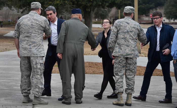 Col. Gregory Gilmour, 315th Airlift Wing commander, front left, Col. Jimmy Canlas, 437th AW commander, front center, and Col. Jeff Nelson, front right, 628th Air Base Wing commander, greet North Atlantic Treaty Organization 
Parliamentary Assembly Defense and Security Committee members during a Congressional Delegation and NATO Partners event Feb. 8, at Joint Base Charleston, S.C. The visit provided NATO members an opportunity to speak with JB Charleston leadership, tour a C-17 Globemaster III, receive a briefing focused on aeromedical evacuation and learn about the Transportation Isolation System’s capabilities.