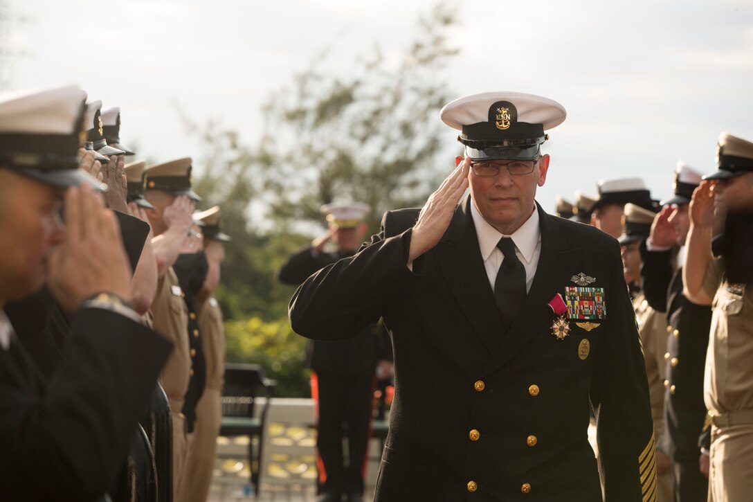III Marine Expeditionary Force Command Master Chief Petty Officer Michael J. Fasano gives a final salute to his fellow service members at Marine Corps Air Station Futenma, Okinawa, Japan, Feb. 9, 2018. Fasano enlisted in the Navy and attended recruit training December 1986 in San Diego, California. He retired after nearly 32 years of honorable service to the U.S. Navy.