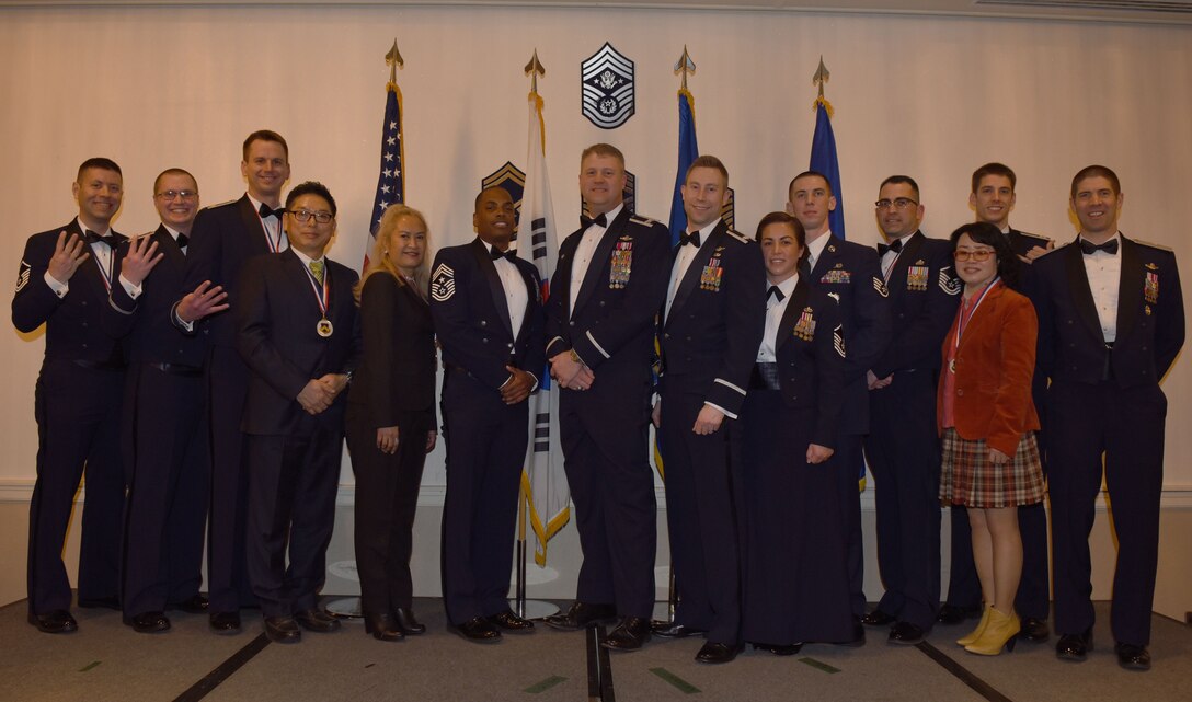 Winners of the 8th Fighter Wing 2017 Annual Awards pose for a photo during the "Night of the Stars" banquet at Kunsan Air Base, Republic of Korea, Feb. 9, 2018. The winners were selected at the top performers in their respective categories for the 2017 calendar year.