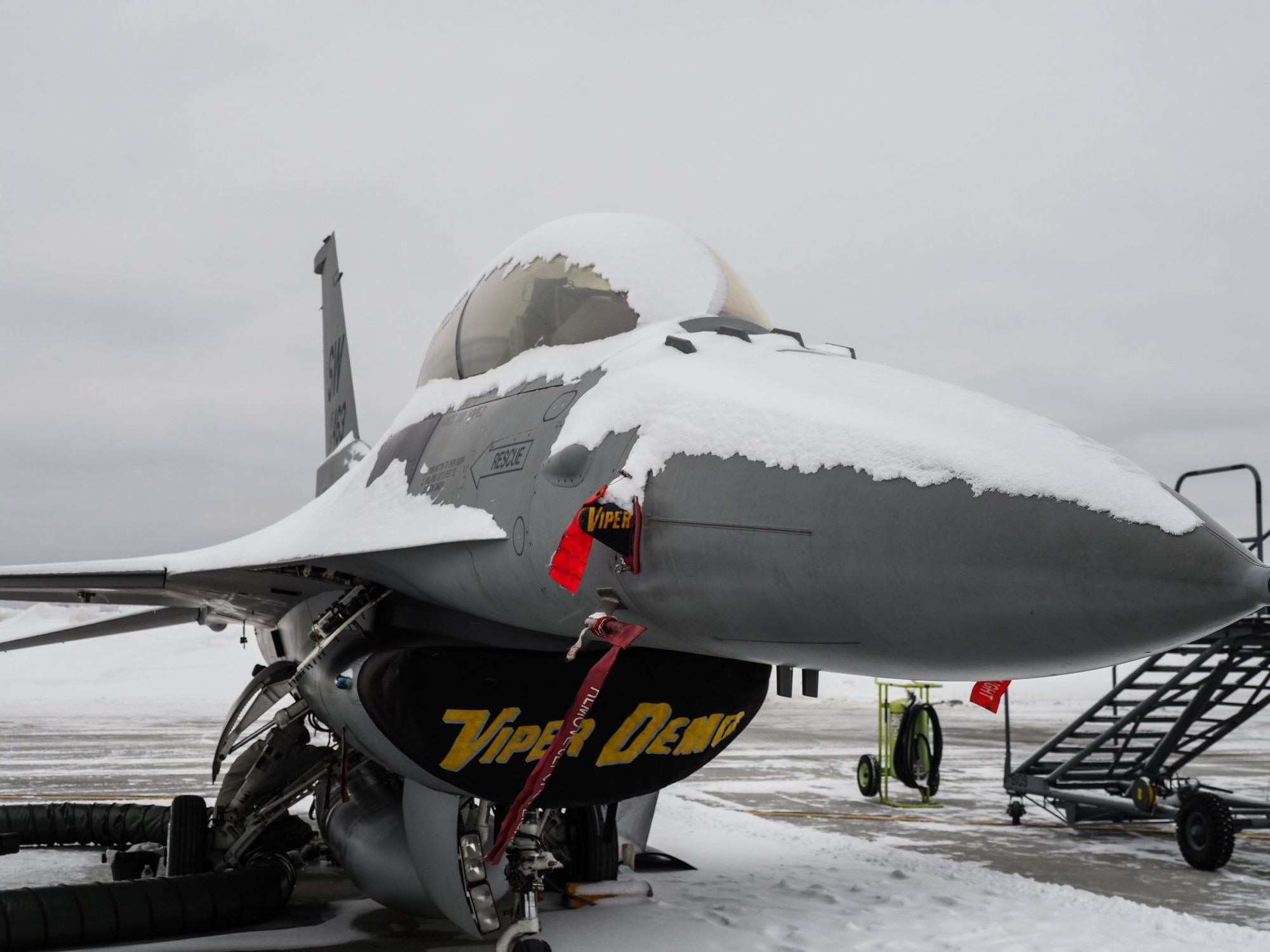 The F-16 Fighting Falcon from the Viper demo team needs a little dusting off before flight after some snow at the 934th Airlift Wing.  The aircraft was part of the Air Force Heritage Flight team that performed the flyover for Super Bowl LII. (Air Force Photo/Paul Zadach)